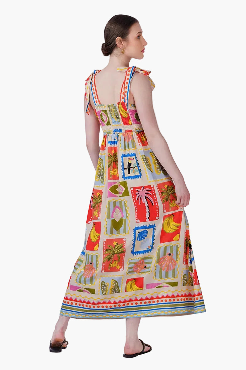 Woman wearing a colorful patterned dress on a white background