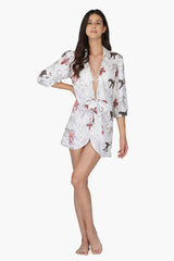 A young woman wearing Jaguar Floral Front Tie Cover Up - Jaguar Apparel Collections by America & Beyond 
